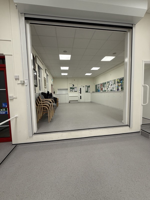 View through the open roller shutter into the small hall